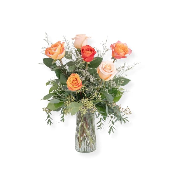 Bouquet of orange and peach roses in a clear glass vase