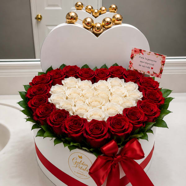 Heart-shaped box of red and white roses with a red ribbon
