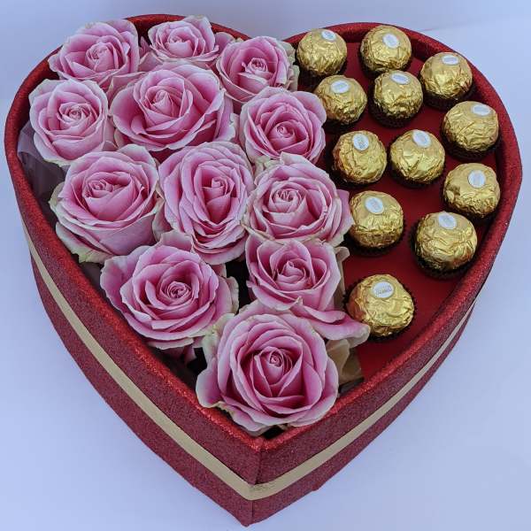 Heart-shaped box with pink roses and gold-wrapped chocolates