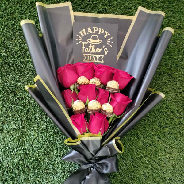 Bouquet of pink roses with chocolates and a Father’s Day card