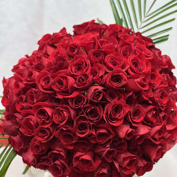 Large bouquet of red roses with palm fronds