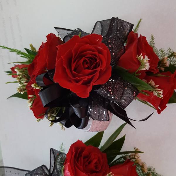 Two red rose bouquets with black ribbon bows