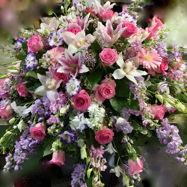 Large bouquet of pink roses, lilies, and purple flowers