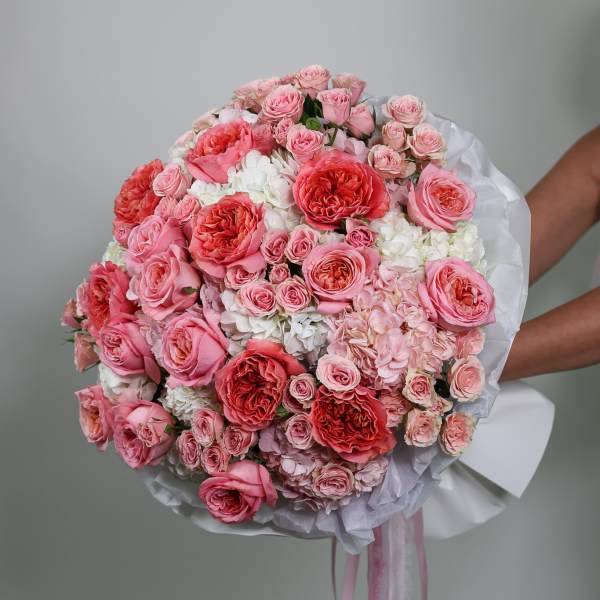 Large pink and white rose bouquet wrapped in white paper