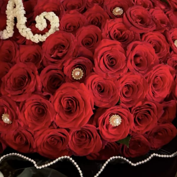 Bouquet of red roses with a jeweled crown and pearl trim