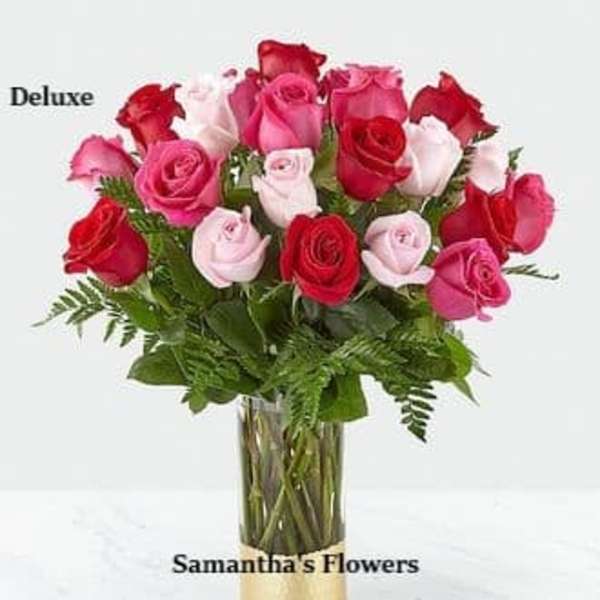 Bouquet of red, pink, and white roses in a glass vase