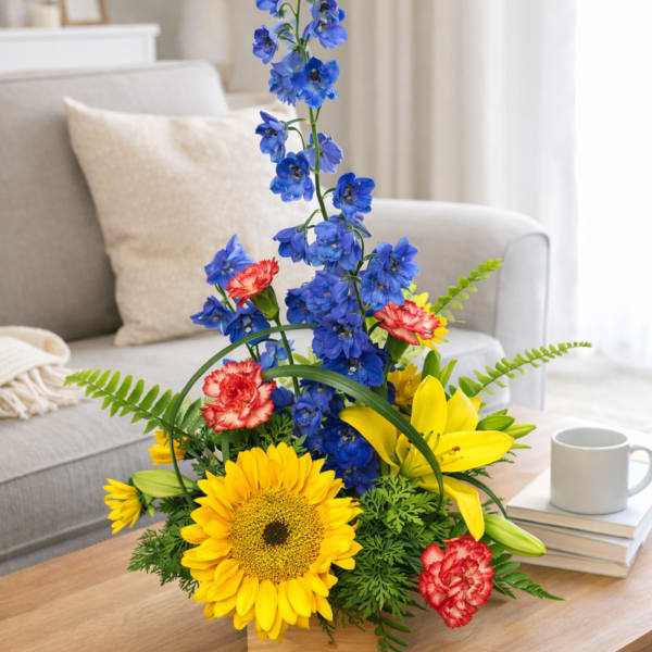 Bright mixed bouquet with blue, yellow, and red flowers in a room setting