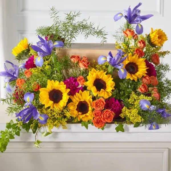 Bright mixed bouquet with sunflowers, purple irises, and orange roses