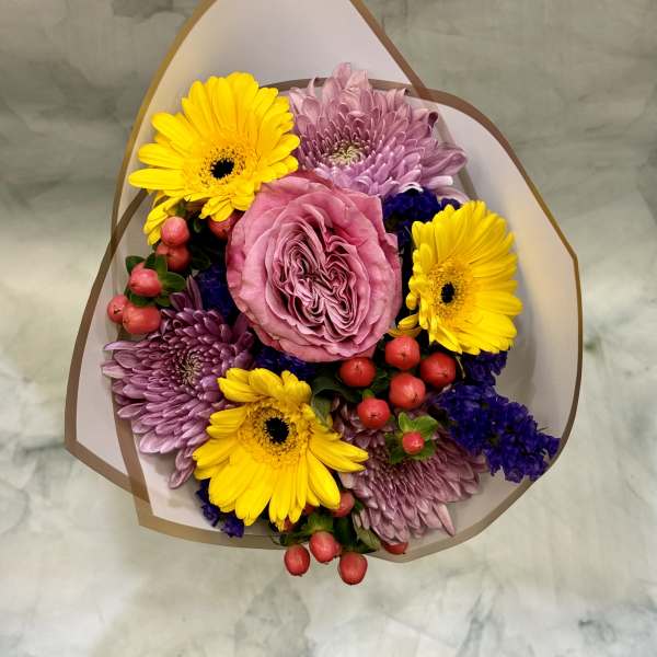 Bouquet of pink roses, yellow gerbera daisies, and purple chrysanthemums