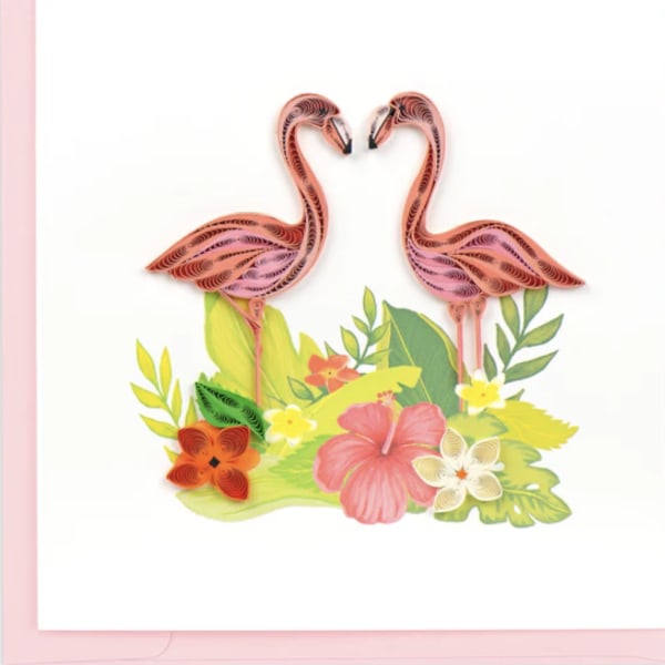 Two pink flamingos above tropical flowers and leaves on a white card