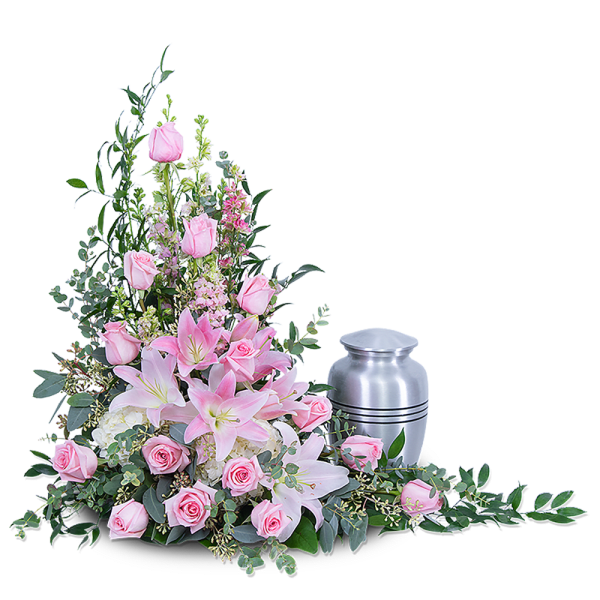 Pink roses and lilies arranged beside a silver urn