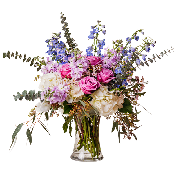 Pink roses and lavender flowers in a clear glass vase