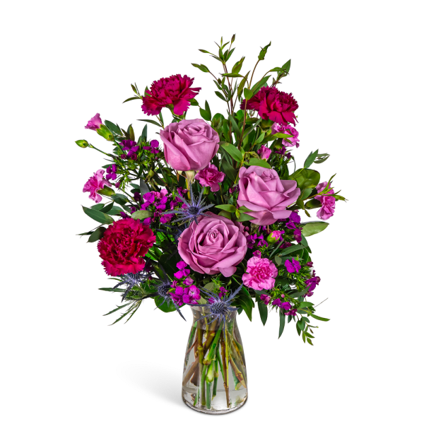 Pink and magenta mixed bouquet in a clear glass vase
