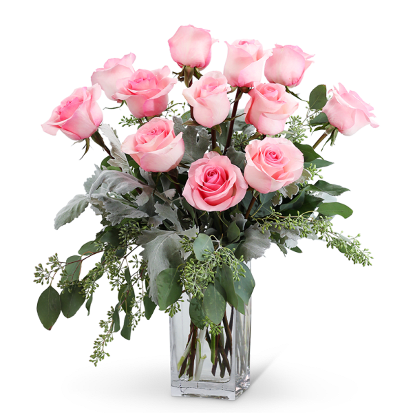 Pink roses arranged in a clear glass vase