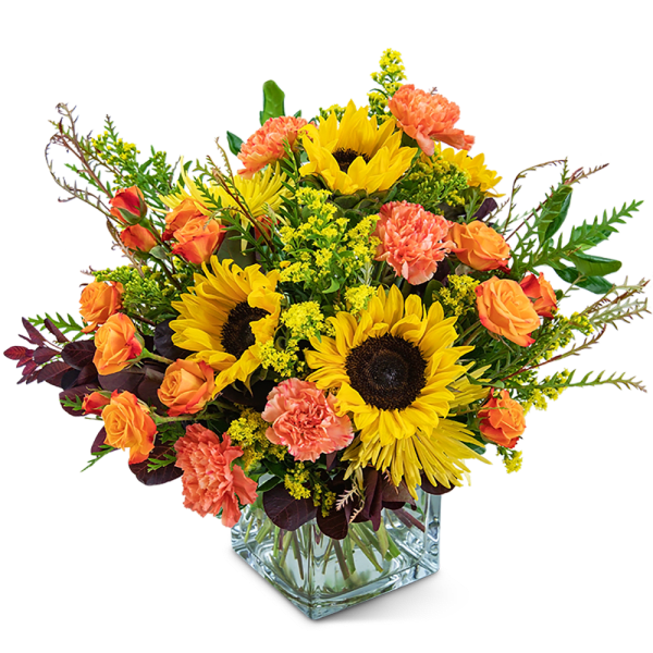 Sunflower and orange carnation bouquet in a clear glass vase