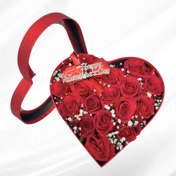 Heart-shaped box of red roses with a Valentine's Day topper