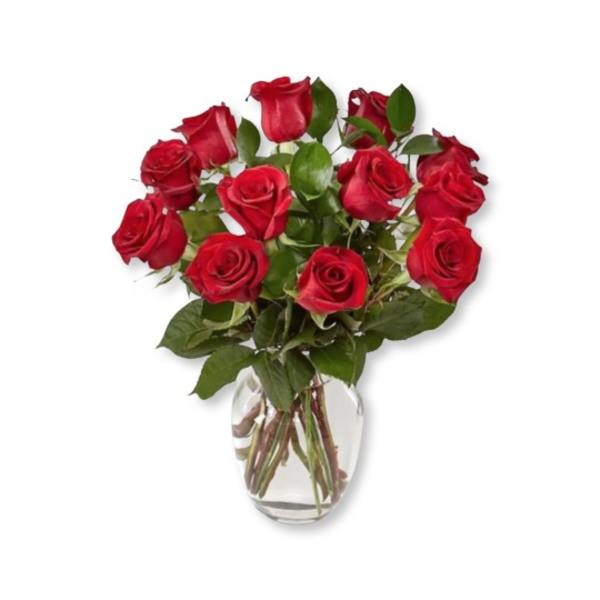 Red roses arranged in a clear glass vase