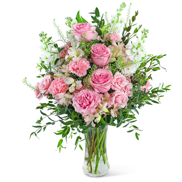 Pink roses and carnations in a clear glass vase