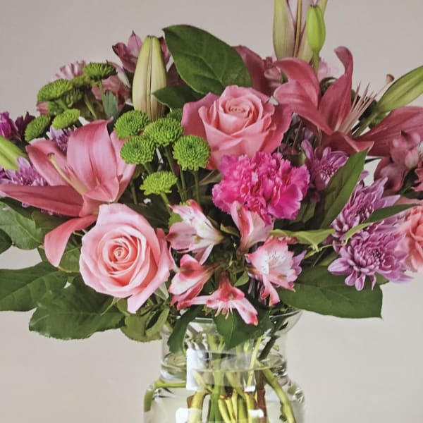 Pink and purple mixed bouquet in a clear glass vase