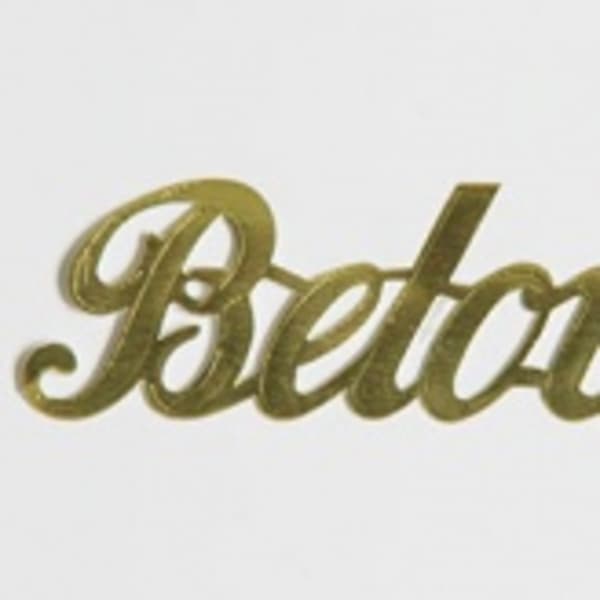 Gold script word "Beloved" on a white background