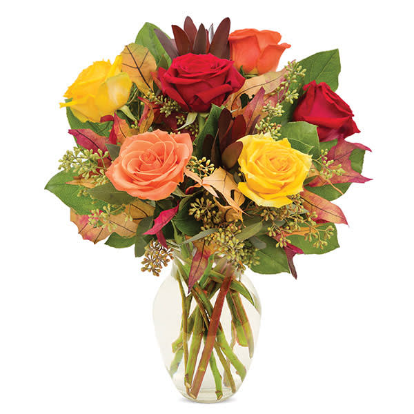 Bouquet of multicolored roses in a clear glass vase