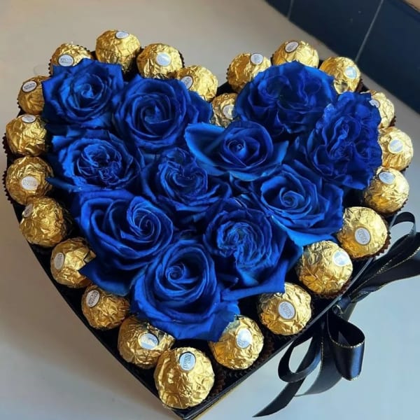 Heart-shaped box with blue roses and gold-wrapped chocolates