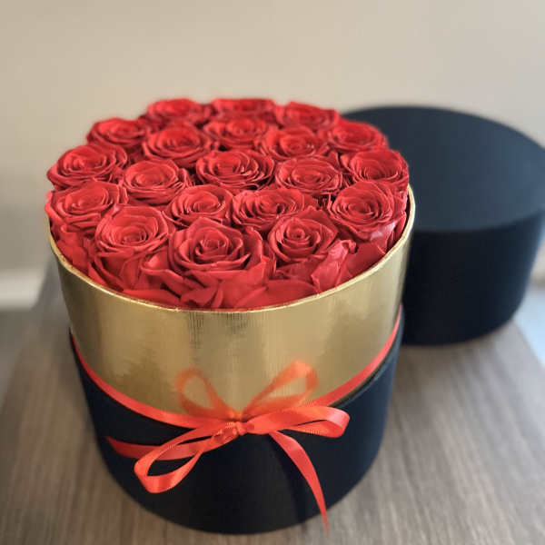 Round box of red roses tied with a ribbon