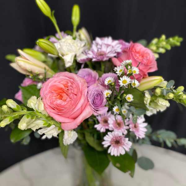 Bouquet of pink and lavender flowers in a glass vase