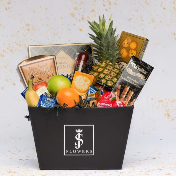 Gift basket with fruit, snacks, and chocolates in a black box