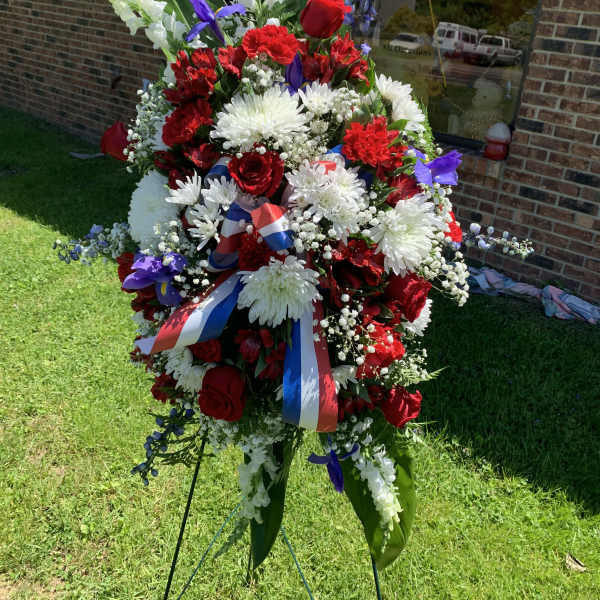 Large standing floral spray with red, white, and purple flowers