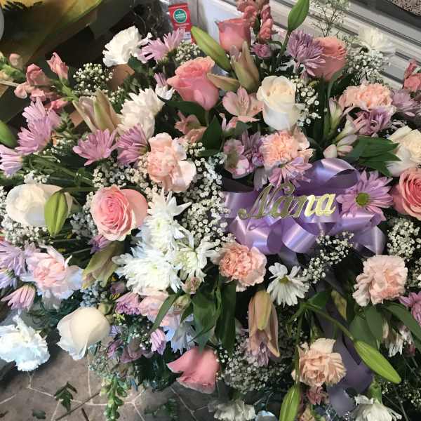 Large floral spray with pink and white roses, daisies, and carnations