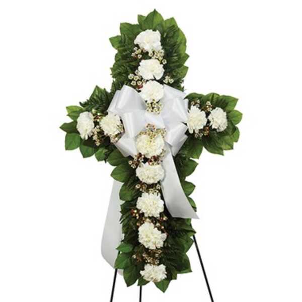 White floral funeral cross on a stand with a satin ribbon