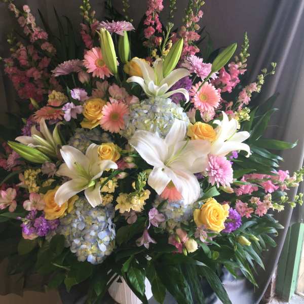 Large mixed bouquet with lilies, roses, hydrangeas, and pink blooms