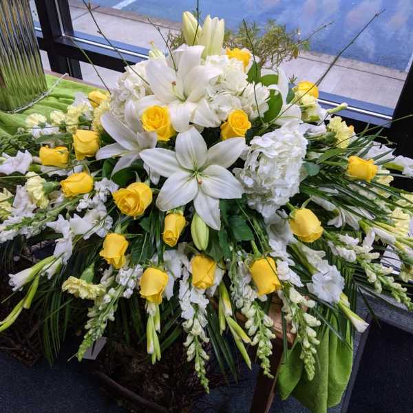 White lilies and yellow roses in a large floral spray