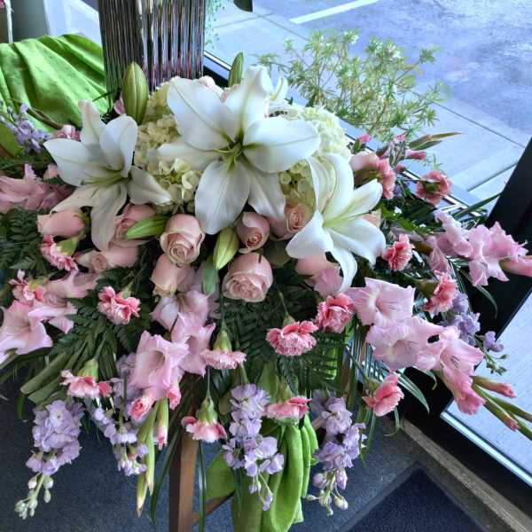 Large pink and white floral arrangement with lilies and roses