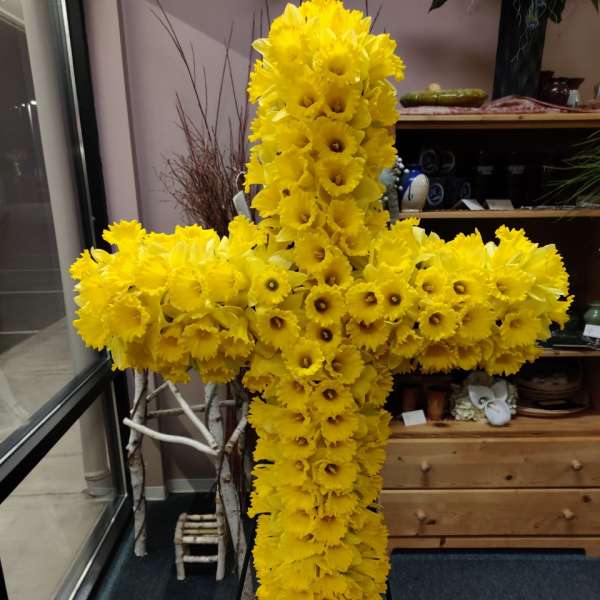 Large yellow floral cross made of daffodils