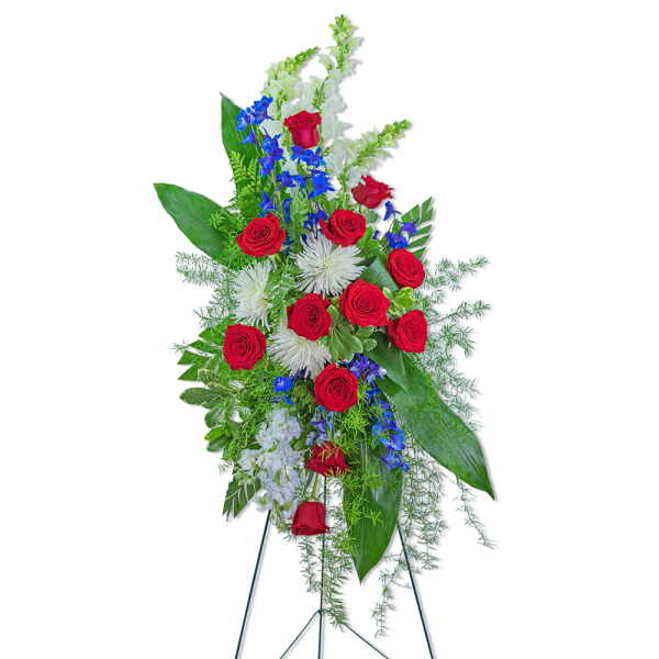 Tall standing floral spray with red roses, white blooms, and blue flowers