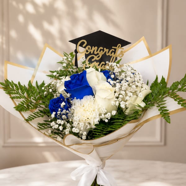 Bouquet of blue and white roses with a graduation topper