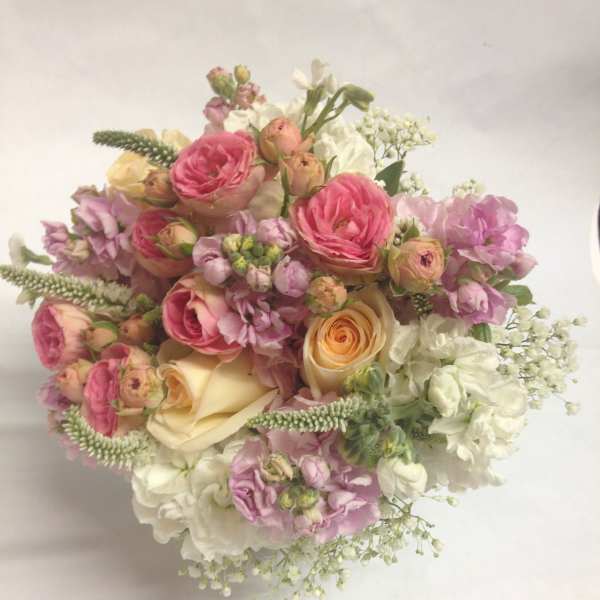 Bouquet of pink and cream roses with white filler flowers