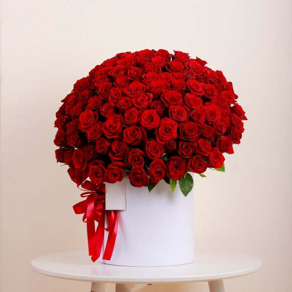 Large bouquet of red roses in a white box with a red ribbon