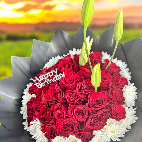 Red rose bouquet with white daisies and lily buds, plus a birthday topper