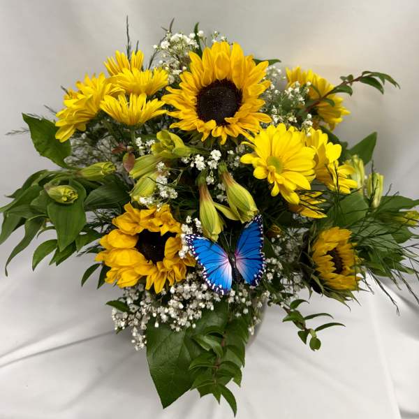 Bouquet of yellow sunflowers and daisies with a blue butterfly decoration