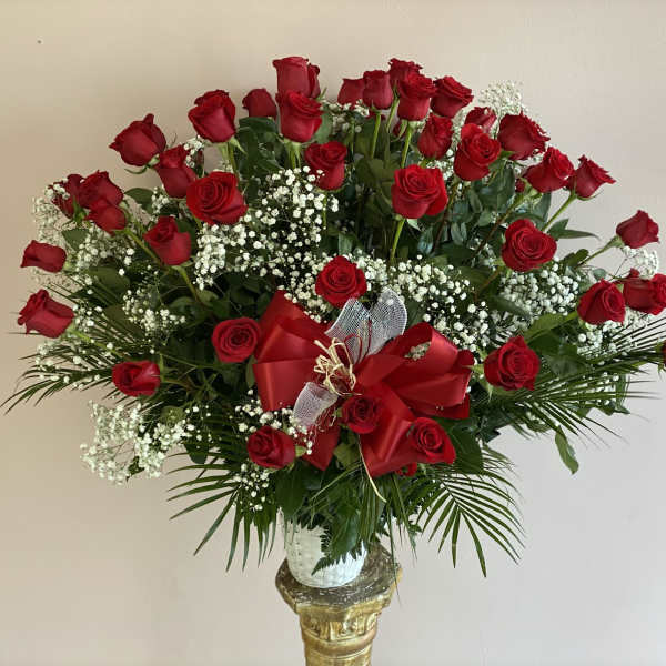 Large bouquet of red roses with baby's breath in a vase