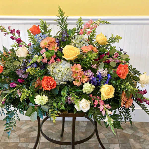 Large mixed floral arrangement with roses, hydrangeas, and snapdragons