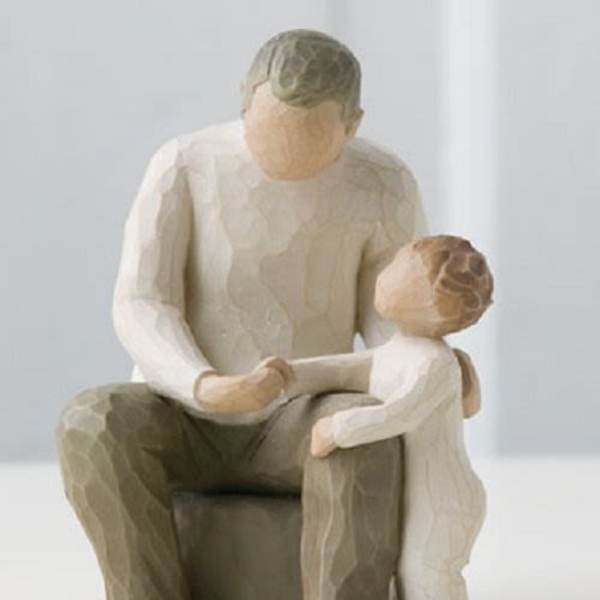 Wooden figurine of an adult and child sitting together