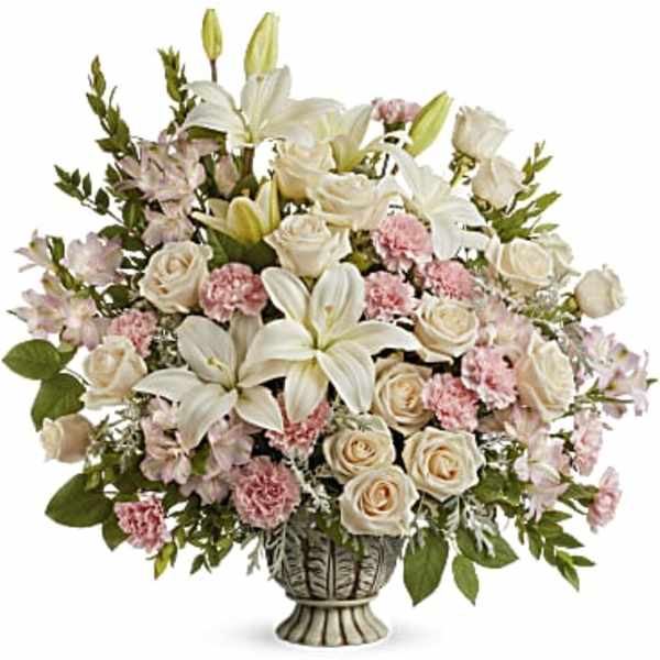 White lilies and pale roses in a decorative vase