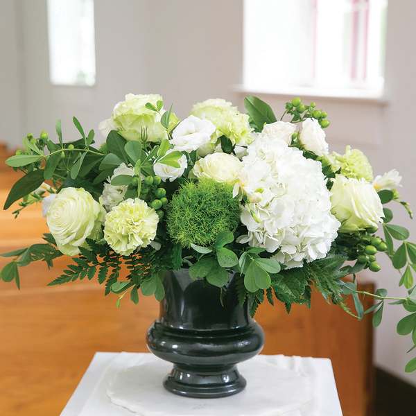 White floral arrangement in a dark vase