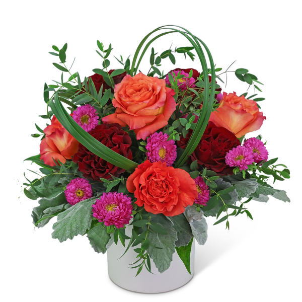 Orange and red roses with pink daisies in a white vase