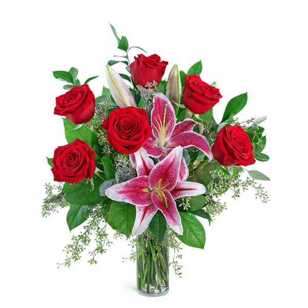Red roses and pink lilies in a clear glass vase