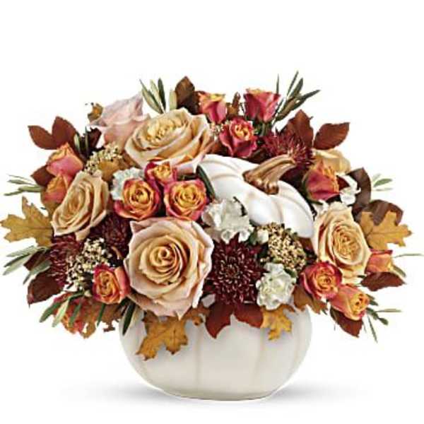 Autumn floral arrangement in a white pumpkin vase with roses and calla lilies
